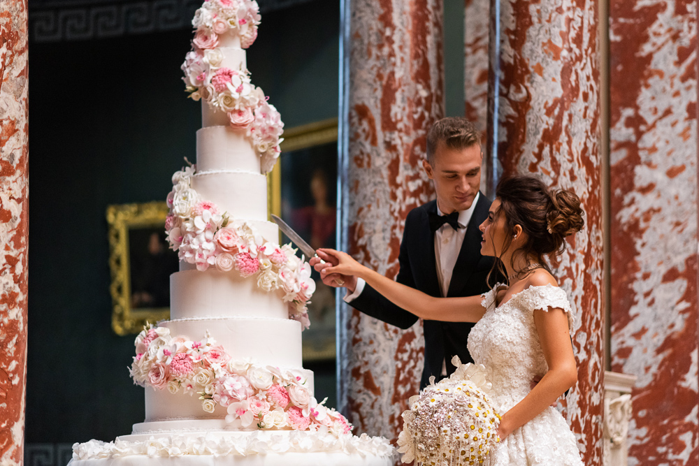 Bride and groom cutting wedding cake