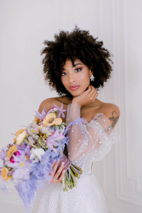 Bride posing for bridal portraits with wedding bouquet