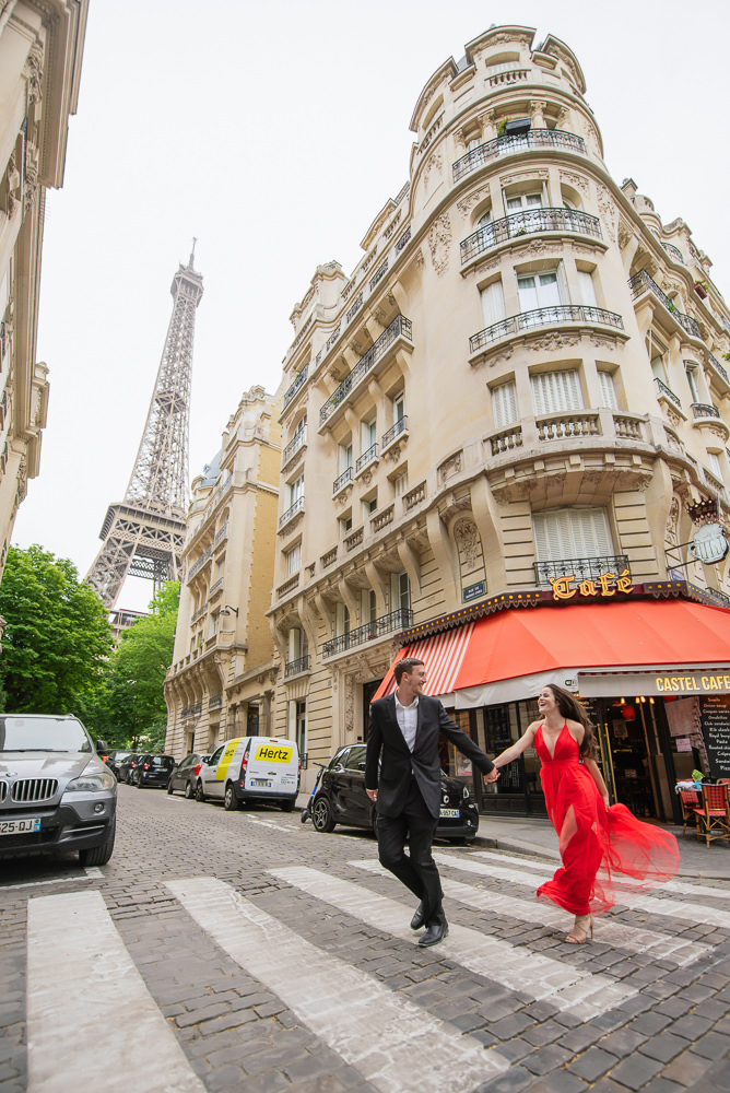 Couple running across the street near the Eiffel Tower