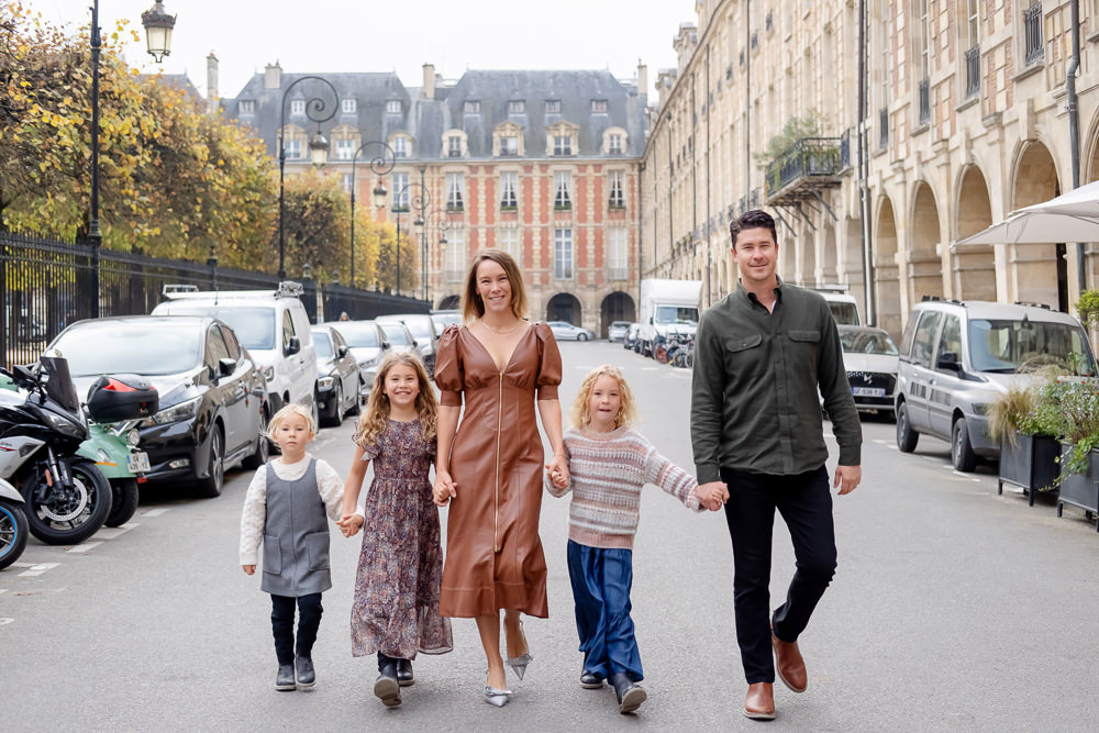 Cute family walking in the streets of Paris around Place des vosges