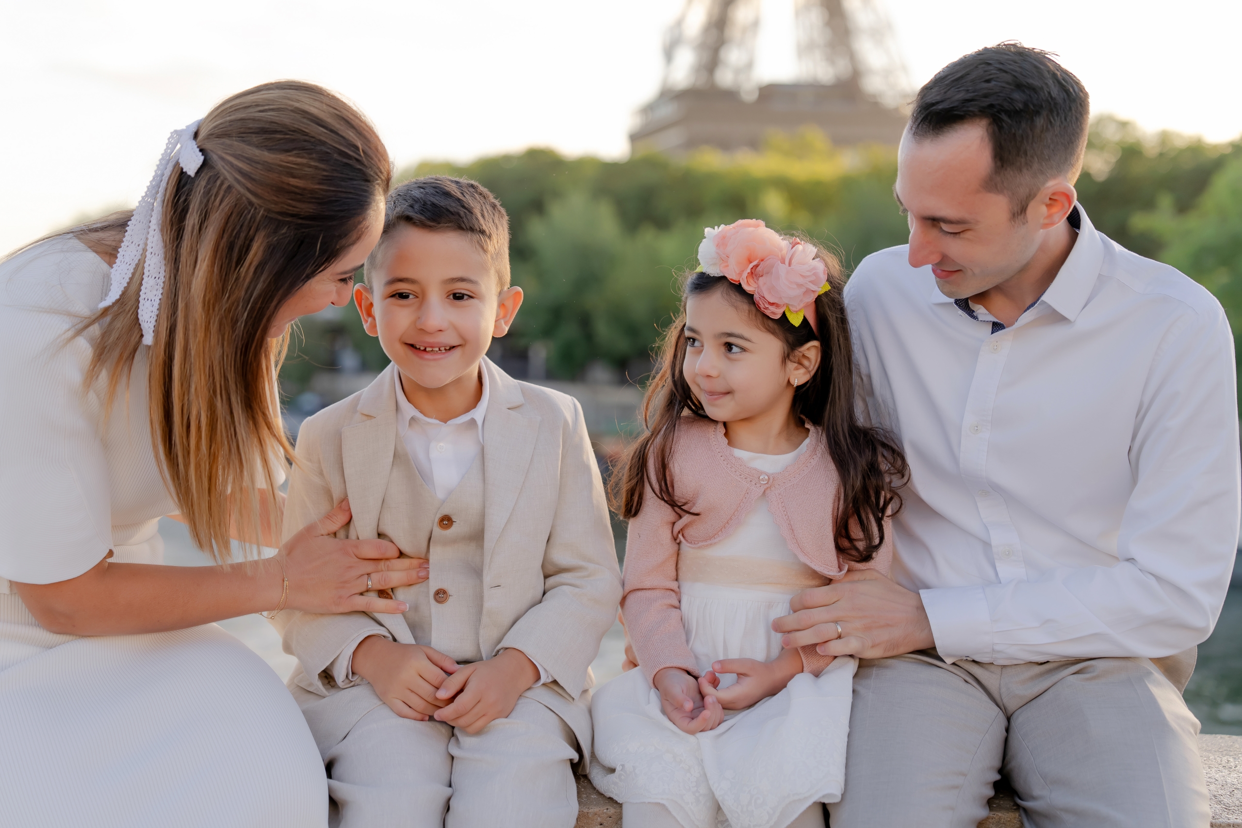 Cute family with small kids having fun at the Eiffel Tower