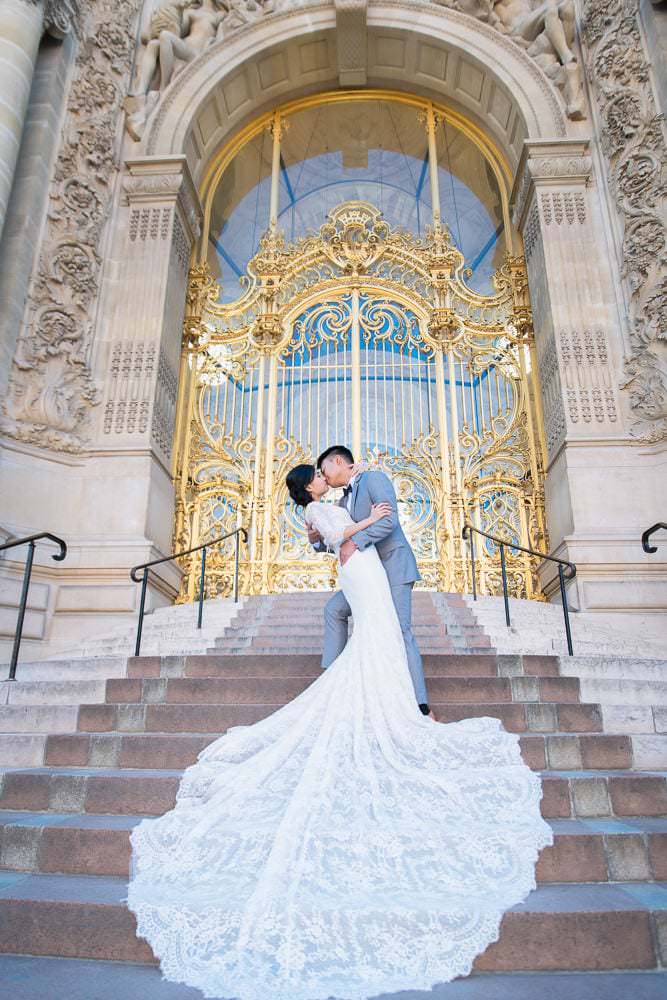 Dramatic kiss captured in front of the Golden Gates of the Petit Palais by Paris elopement photographer Fran Boloni