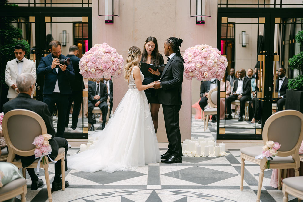 Couple eloping in front of officiant at four Seasons in Paris