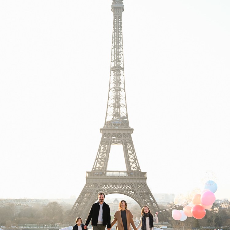 Happily smiling family walking for family portraits in Paris