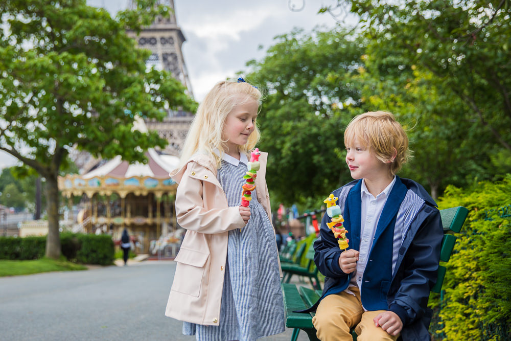 Kids eating colorful ice cream during their Eiffel Tower family photoshoot