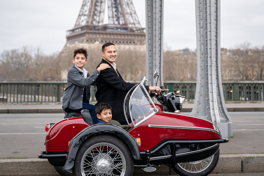Kids posing with a motorcycle on the Bir Hakeim bridge in Paris