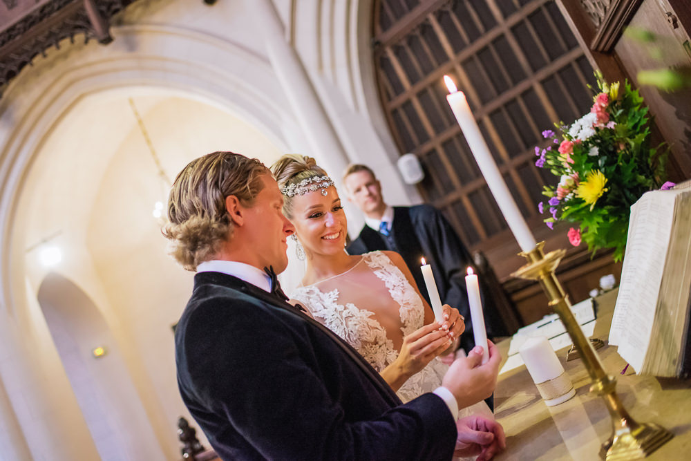 Lighting up candles during elopement in paris ceremony in church