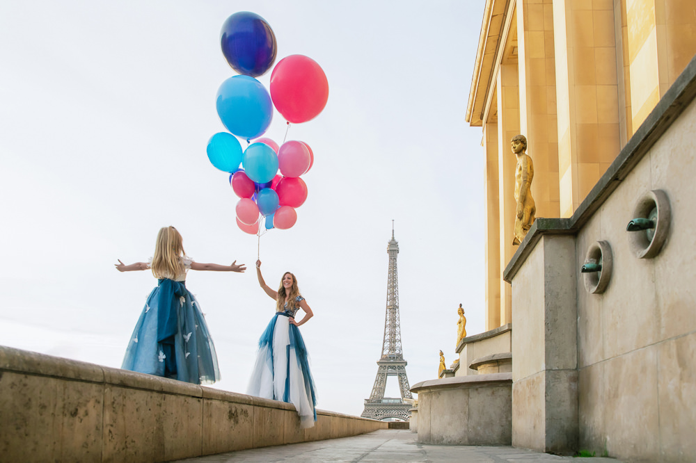 Mother and daughter having a fun photoshoot with colorful balloons at Trocadero