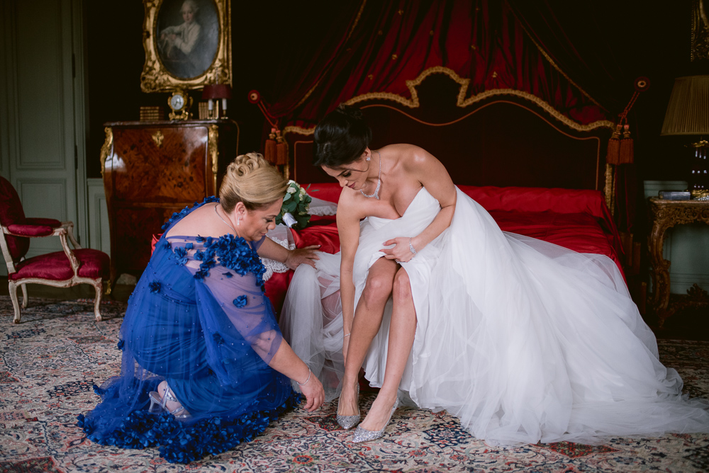 Mother helping bride to get ready for her special day