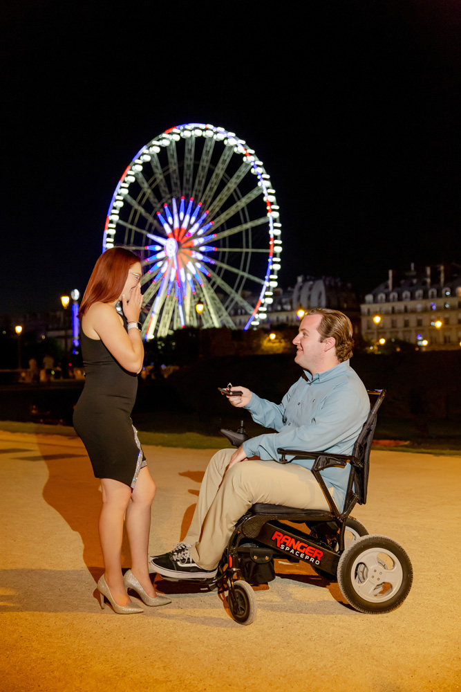 Night Paris proposal with him offering the ring sitting in a wheelchair 
