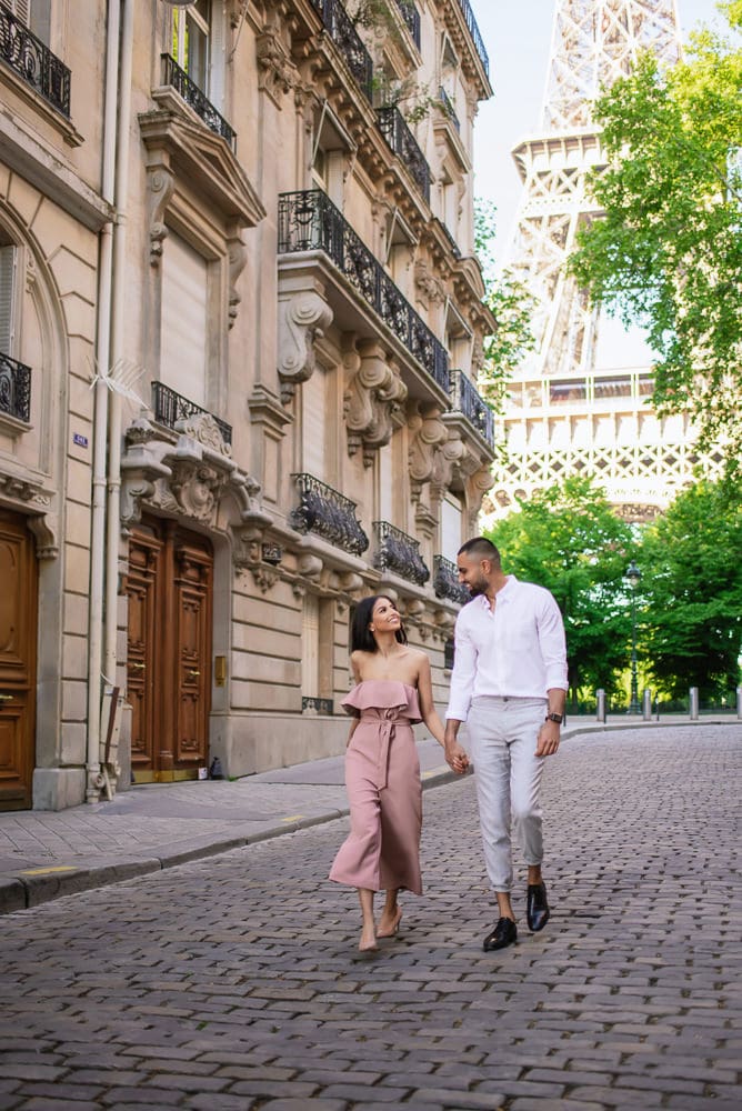 couple walking on the streets of Paris with the Eiffel Tower in the background