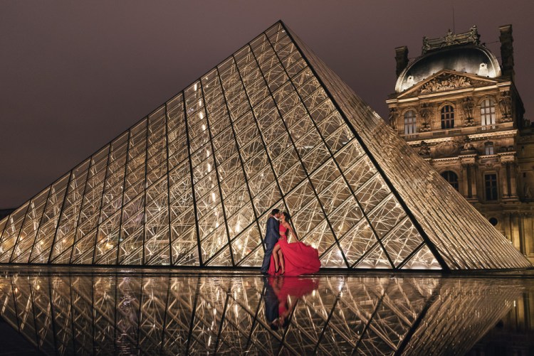The Louvre Pyramid reflected in the fountains water